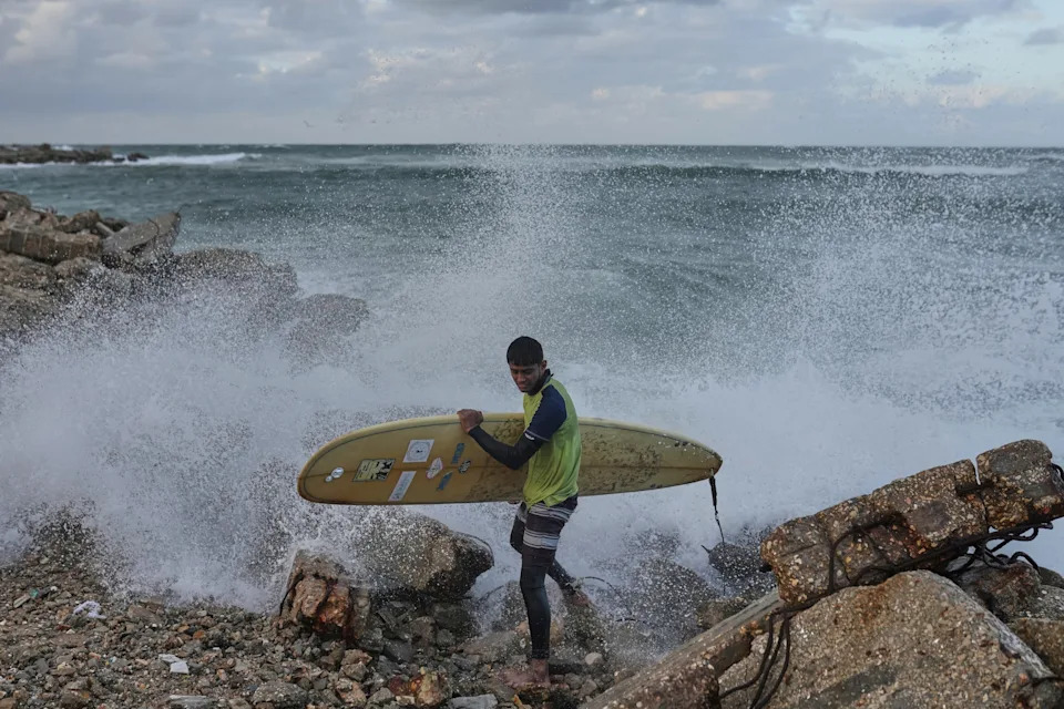 Against the Odds: Surfers Ride Waves Along Gaza City's War-Damaged Shoreline