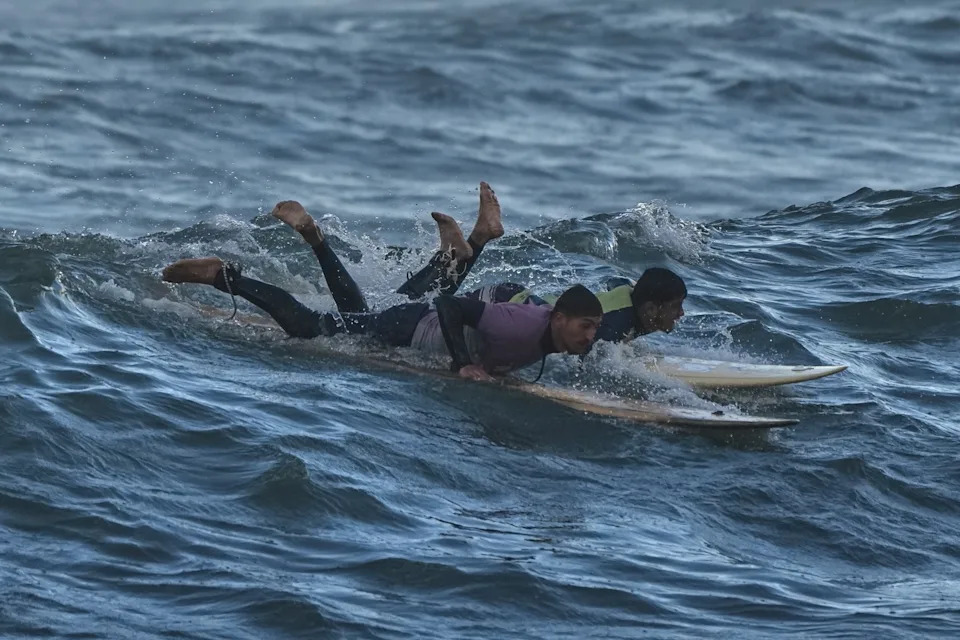 Against the Odds: Surfers Ride Waves Along Gaza City's War-Damaged Shoreline