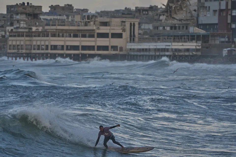 Against the Odds: Surfers Ride Waves Along Gaza City's War-Damaged Shoreline
