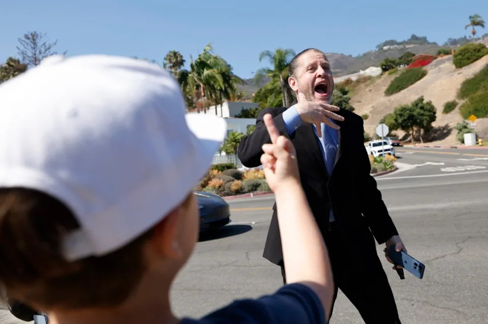 Mother Urges Son To Flip Off MAGA Supporters, Shouts Graphic Accusations Ahead Of Trump’s LA Visit